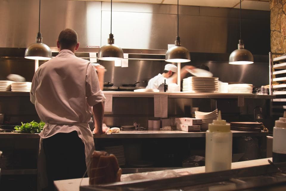 The chef working at the pass in the open kitchen