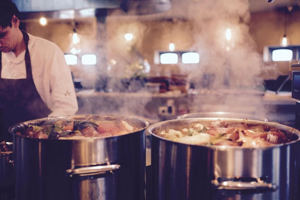 Steam rising from stockpots in the kitchen