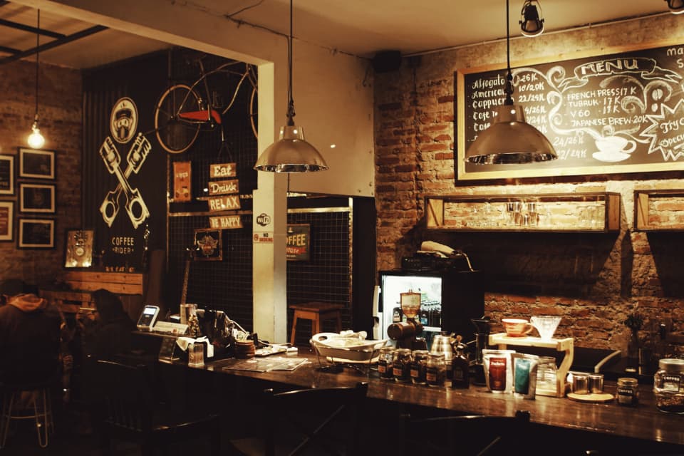 The bar with shelves of bottles and warm lights