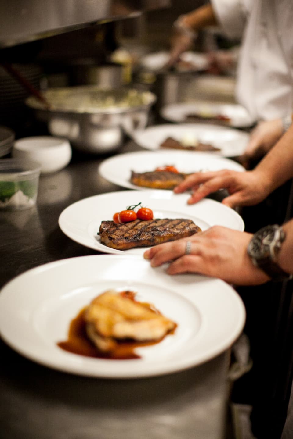 Plates lined up at the pass, ready to go out